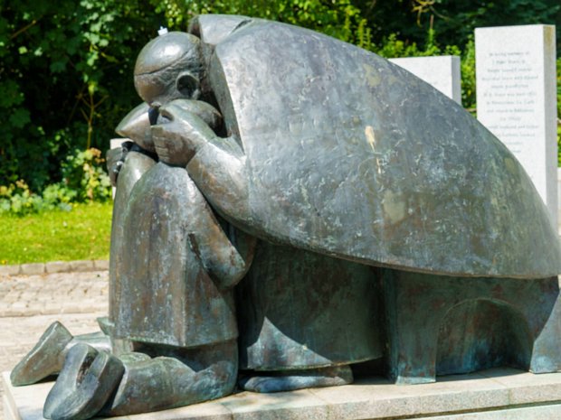 BY IMOGEN STUART 2024 ronze statue of pope John Paul II embracing two kneeling children, based on a photograph taken during the Pope's visit...
